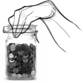 A hand reaches into a jar of pennies.