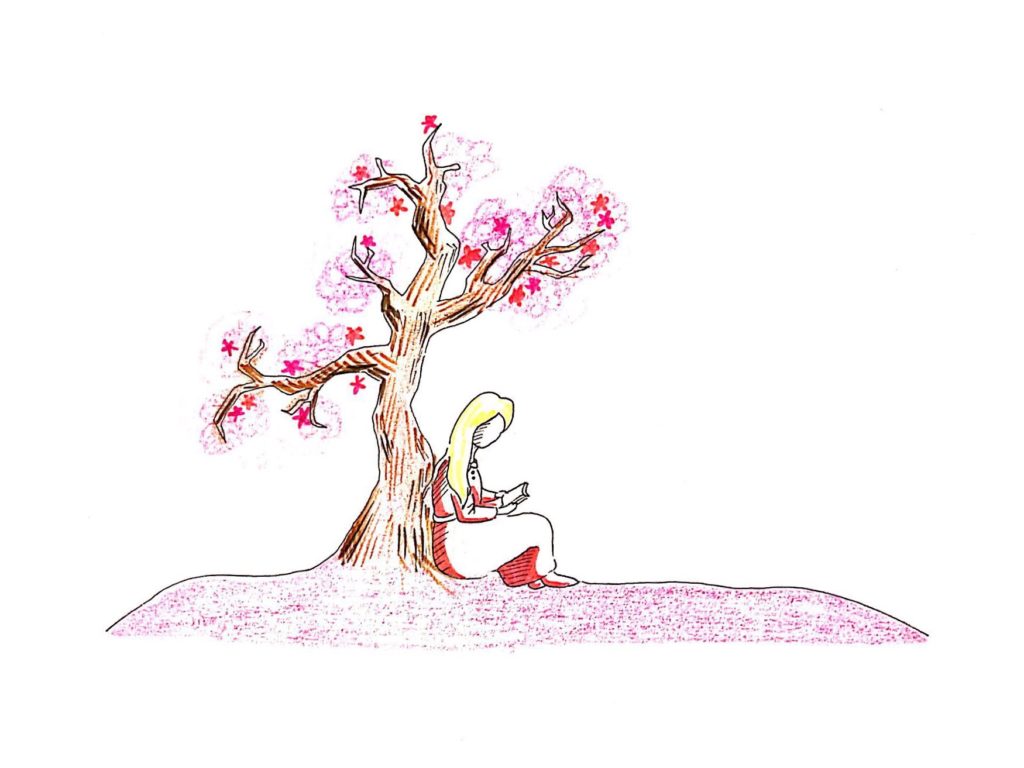 A person sits below a tree of pink blossoms reading a book.