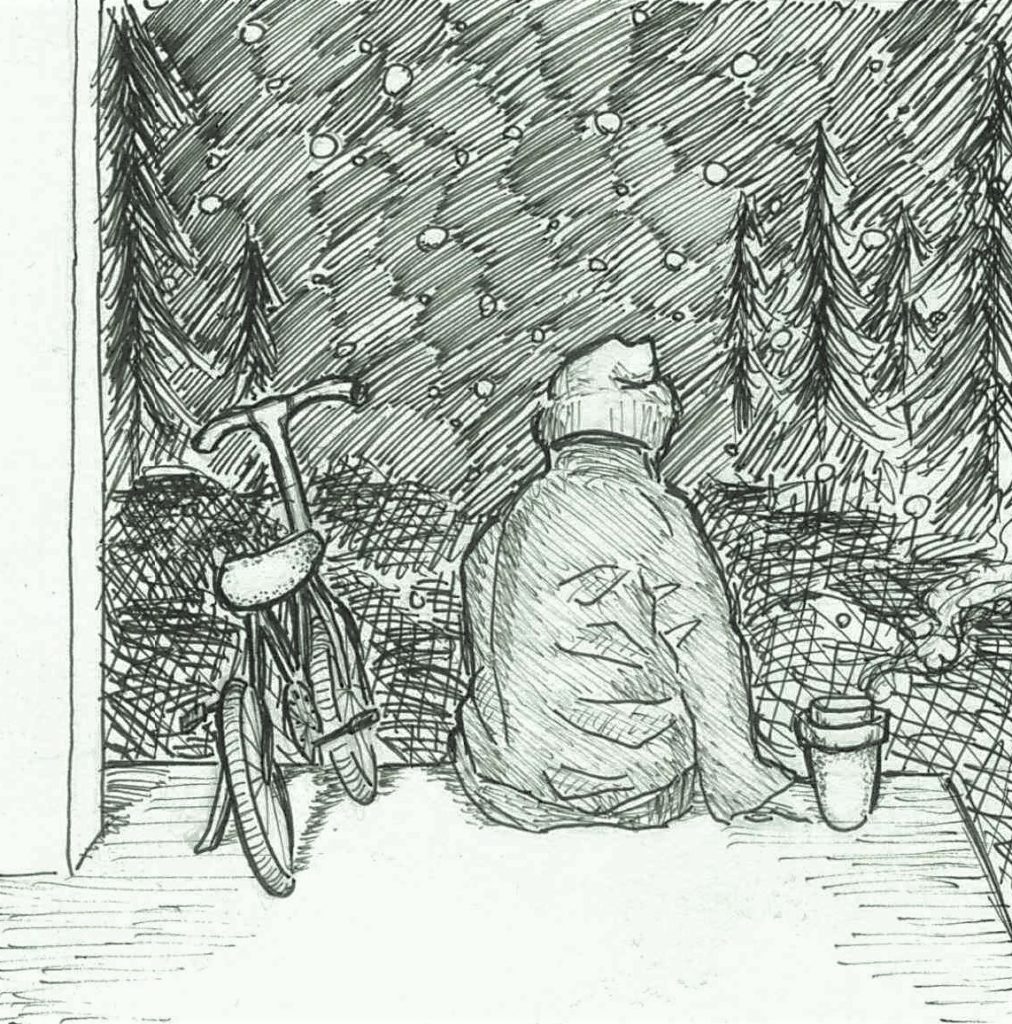 An individual sits on their porch, staring out at the landscape with a bike beside them.